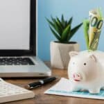 front-view-office-items-with-growth-chart-piggy-bank